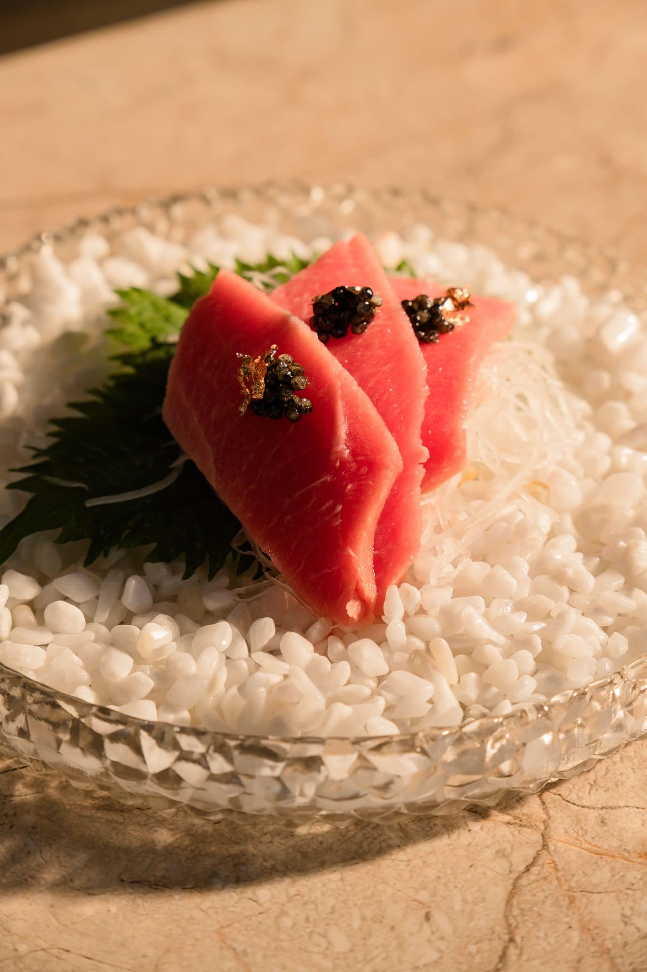 Tuna nigiri topped with caviar, served on ice at Kumo omakase in Ubud